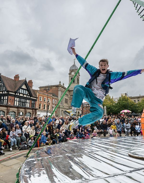 Happy person jumping in Derby Market Place