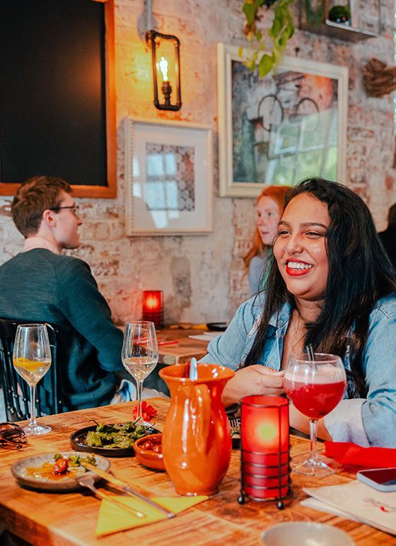 A woman enjoying a selection of tapas at Lorentes Darley Abbey
