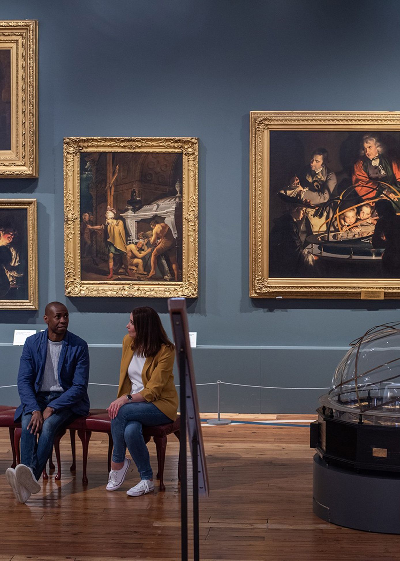 A couple sat in the Joseph Wright gallery